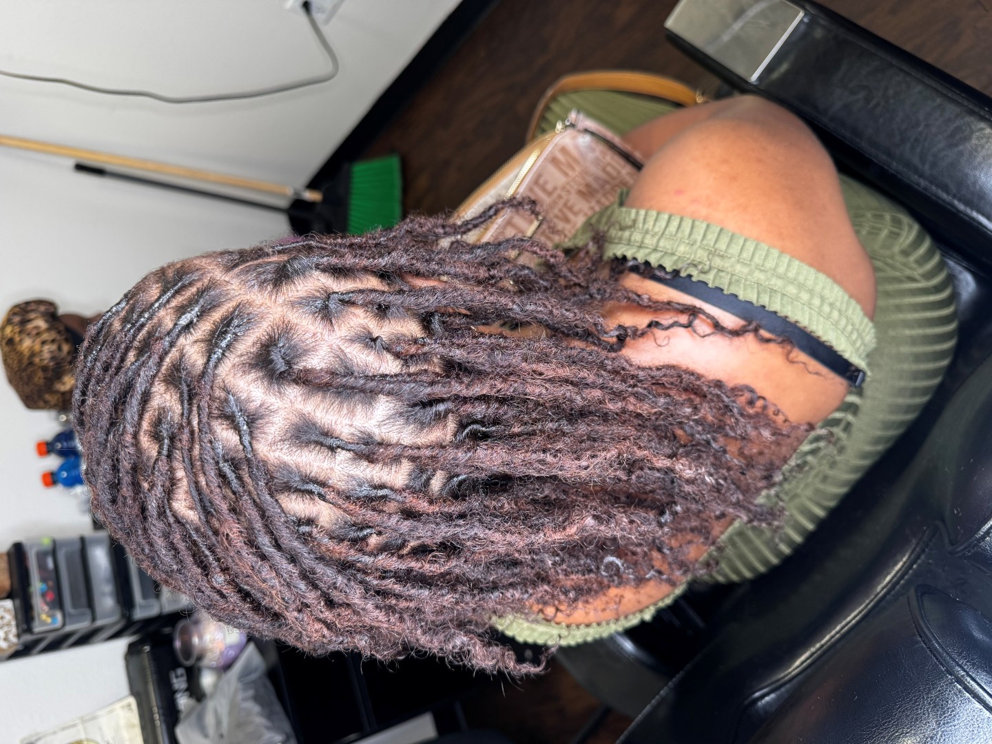 black woman after starting the loc installation