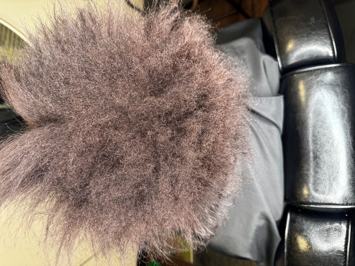 woman with frizzy hair in a salon chair